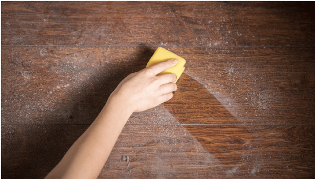 Dust on a table being wiped off