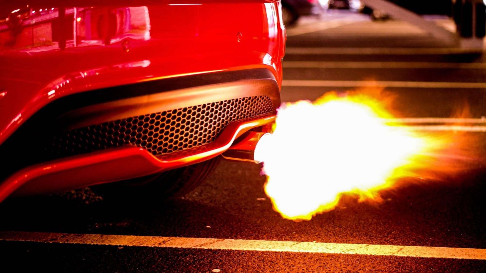 A red car exhaust system emitting fire
