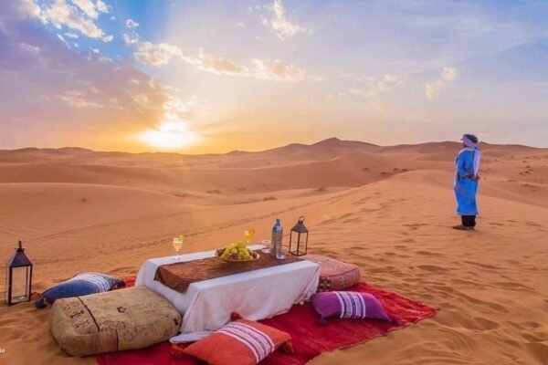 Camel caravan crossing the golden dunes of Merzouga on a Marrakech to Merzouga desert tour