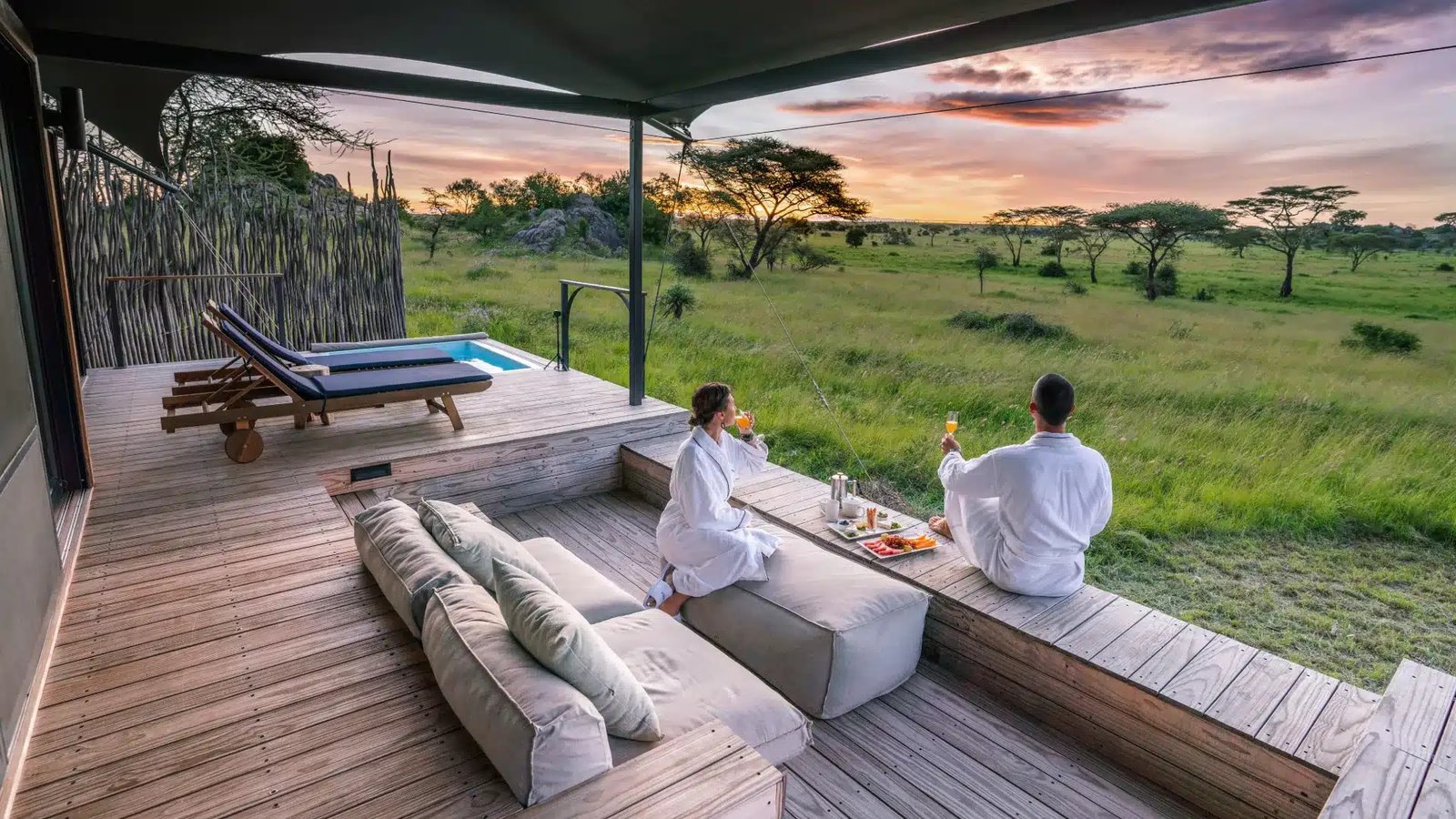 Luxury safari lodge in Tanzania with tents and lodges surrounded by wildlife and scenic landscapes.