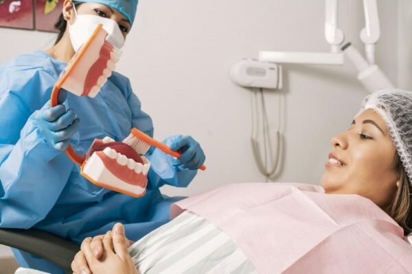 6 Preventive Habits General Dentists Say Patients Should Adopt Dentist explaining preventive dental habits to a patient.