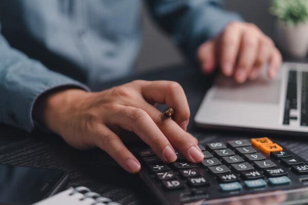 The Value Of Outsourcing Payroll To An Accounting Firm Business owner discussing payroll outsourcing with an accounting professional.