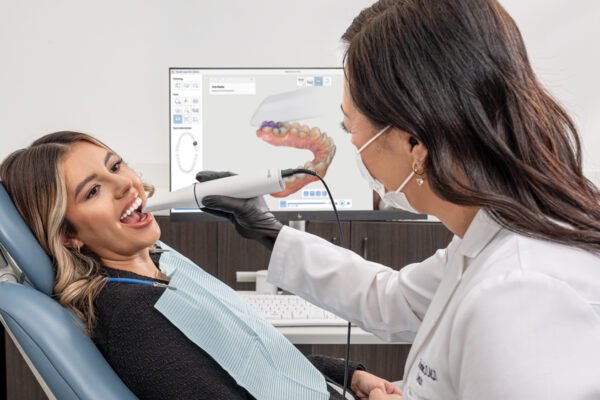 Dentist using advanced digital dental technology during a family dentistry exam