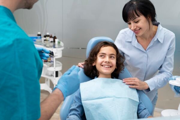 Family dentist guiding a teenage patient through cosmetic dentistry options
