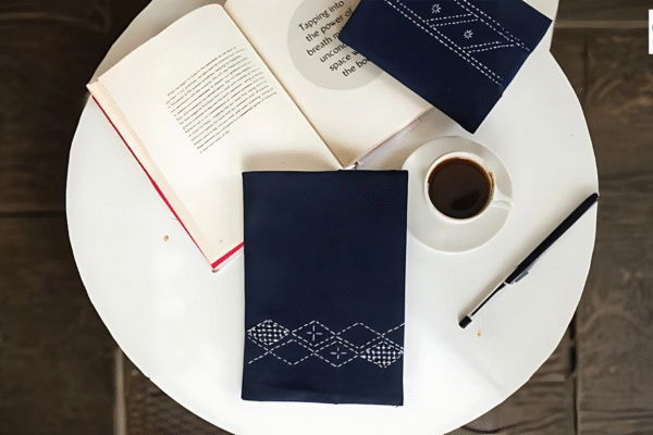 Books, cup of coffee and a pen on a table