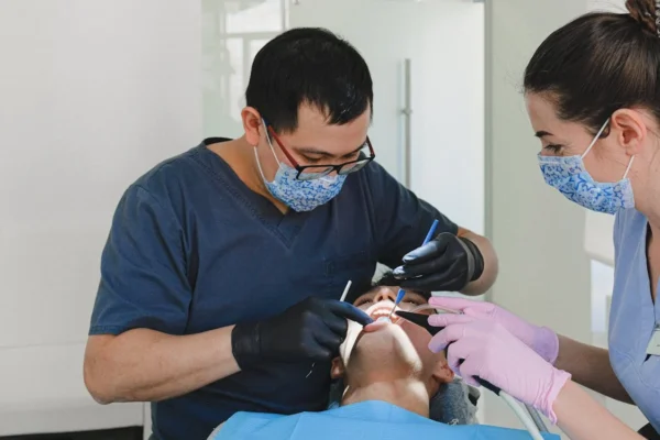 Dentist performing preventive dental check-up to reduce emergencies