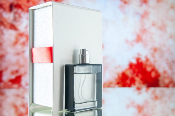 Perfume Bottle With Gift Box and Red Ribbon Backdrop