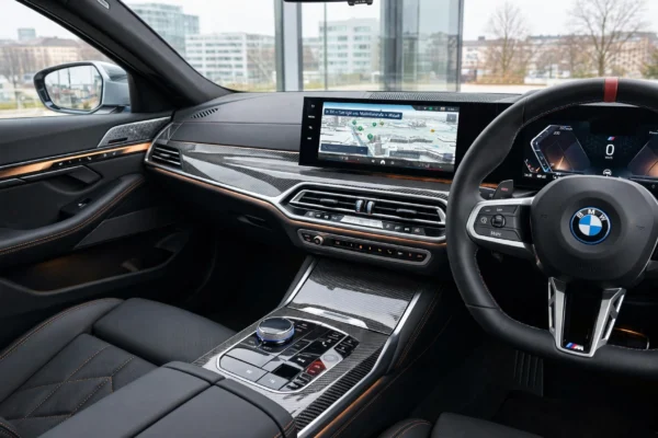 BMW iDrive safety systems featured on curved display inside modern BMW cabin with ambient lighting