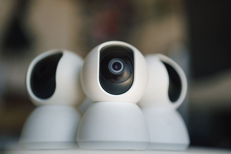 Professional IP security cameras from leading brands mounted on wall displaying network connectivity and integration features