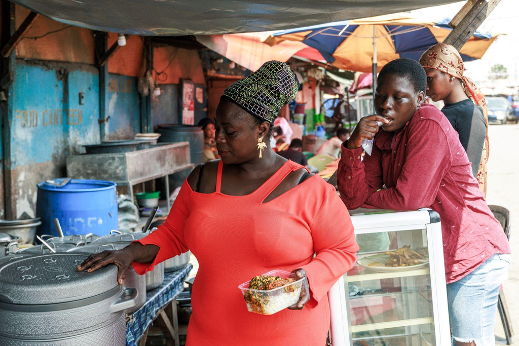 Nigerian food vendor selling affordable meals from a small roadside stall